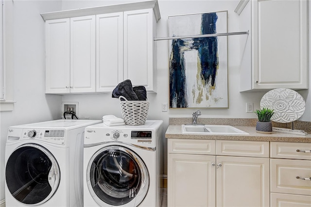 laundry area with sink, cabinets, and washer and dryer