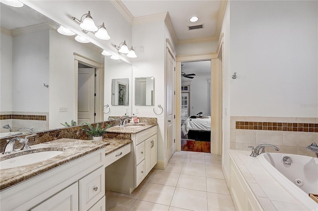 bathroom featuring tile patterned floors, vanity, crown molding, and tiled tub