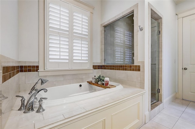 bathroom featuring tile patterned floors and independent shower and bath