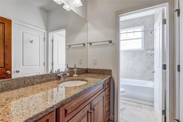 full bathroom featuring tiled shower / bath combo, vanity, tile patterned flooring, and toilet