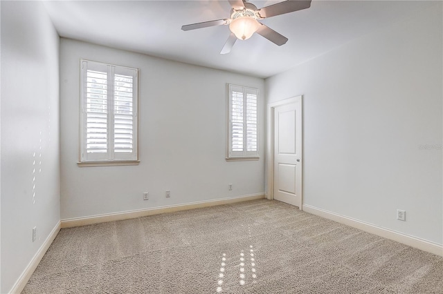 unfurnished room featuring ceiling fan and light carpet