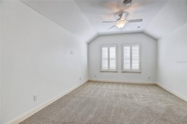 additional living space featuring vaulted ceiling, light colored carpet, and ceiling fan