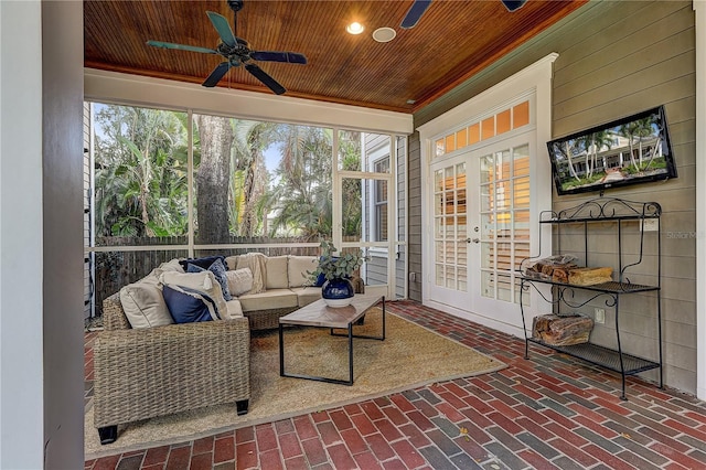 sunroom / solarium featuring french doors, ceiling fan, and wood ceiling