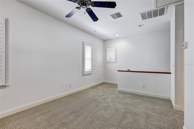 carpeted spare room with ceiling fan