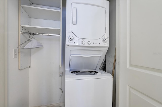 washroom featuring stacked washer and clothes dryer