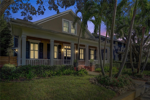 view of front of house featuring a yard and covered porch