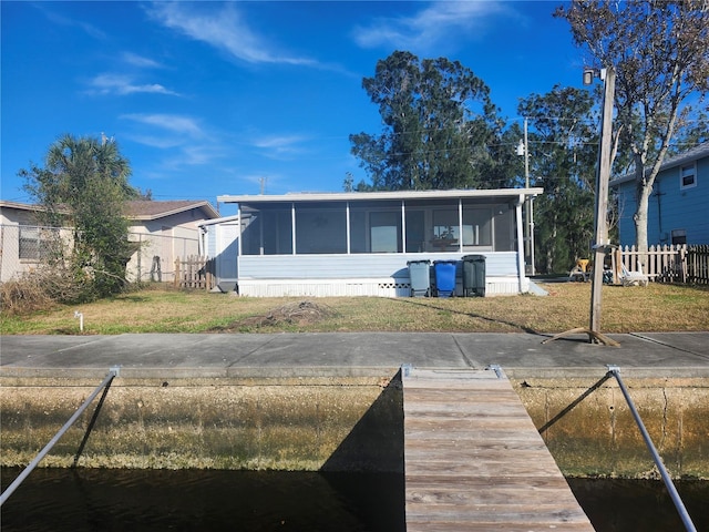 view of front of house with a sunroom and a front yard