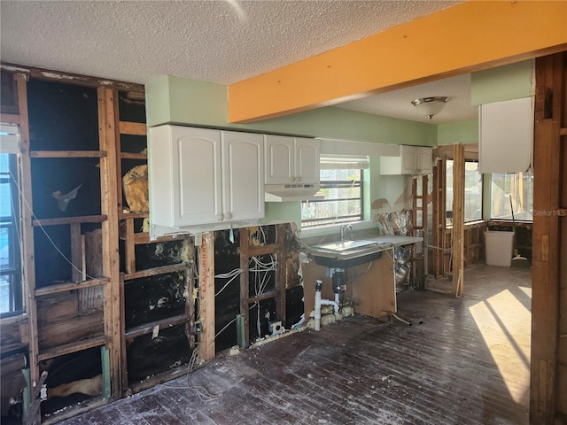 kitchen featuring white cabinetry and a textured ceiling