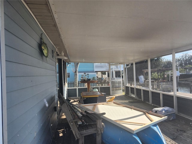 unfurnished sunroom with a water view