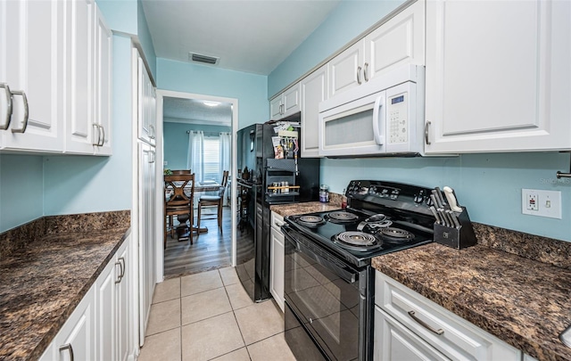 kitchen featuring black appliances, white cabinetry, light hardwood / wood-style floors, and dark stone countertops