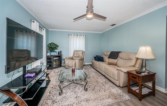 living room featuring ornamental molding, a textured ceiling, wood-type flooring, and ceiling fan