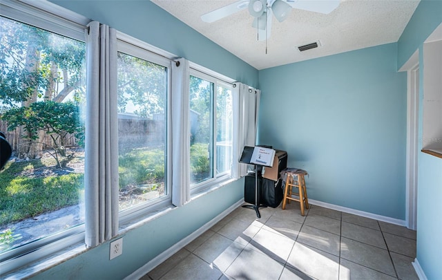 sunroom / solarium featuring a healthy amount of sunlight and ceiling fan