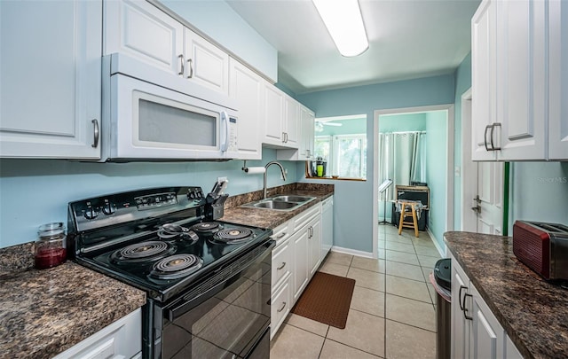 kitchen featuring white appliances, white cabinetry, and sink