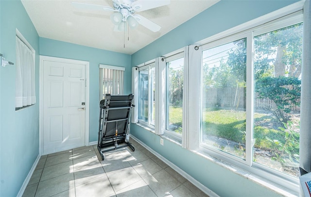 sunroom / solarium featuring ceiling fan