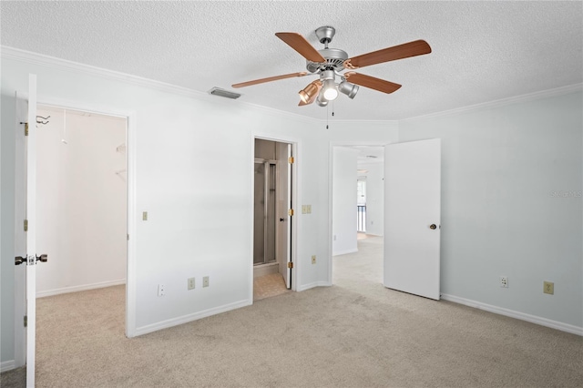 unfurnished bedroom with ceiling fan, a spacious closet, connected bathroom, light colored carpet, and a closet