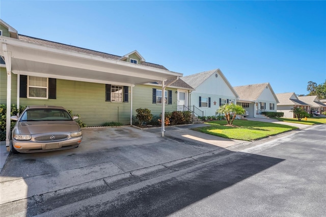 ranch-style home with a front lawn and a carport