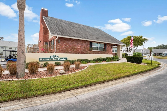 view of side of home featuring a lawn