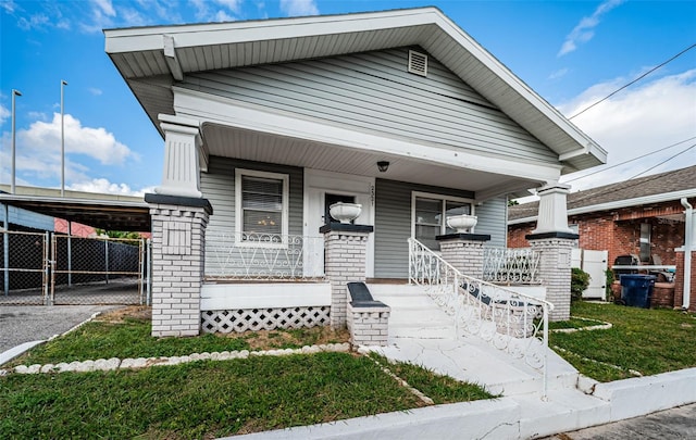 view of front of property featuring a carport and a porch