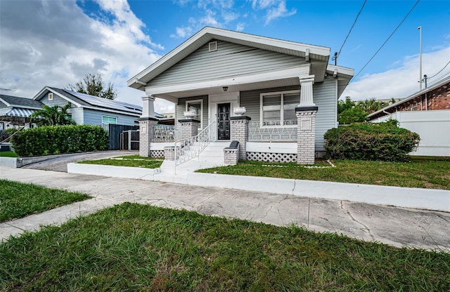 view of front facade featuring a front yard and a porch