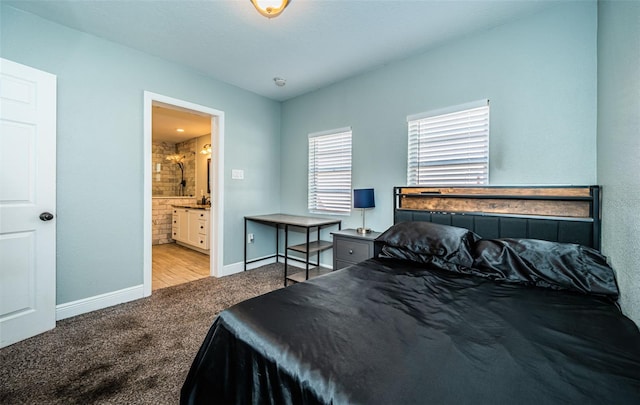 bedroom featuring light carpet and connected bathroom