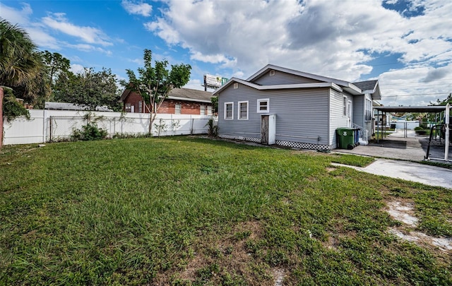 view of home's exterior with a patio and a yard