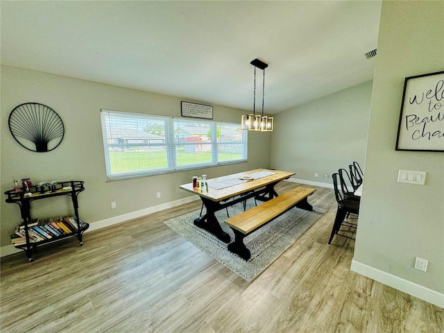 dining room featuring an inviting chandelier and light wood-type flooring