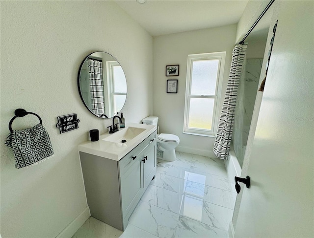 bathroom with vanity, toilet, and curtained shower