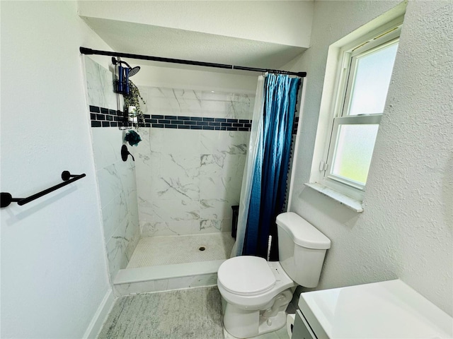 bathroom featuring a healthy amount of sunlight, curtained shower, and toilet