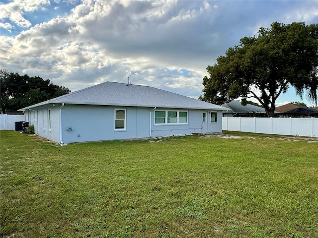 rear view of property featuring a yard