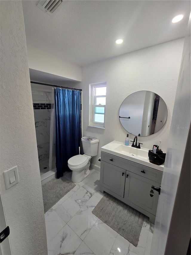 bathroom featuring vanity, curtained shower, and toilet