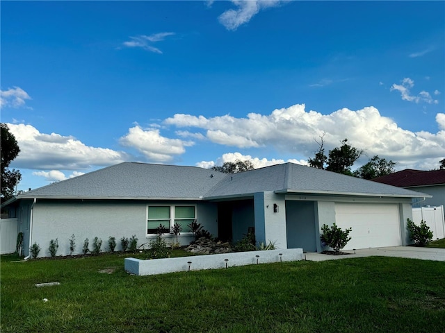 ranch-style house featuring a garage and a front lawn