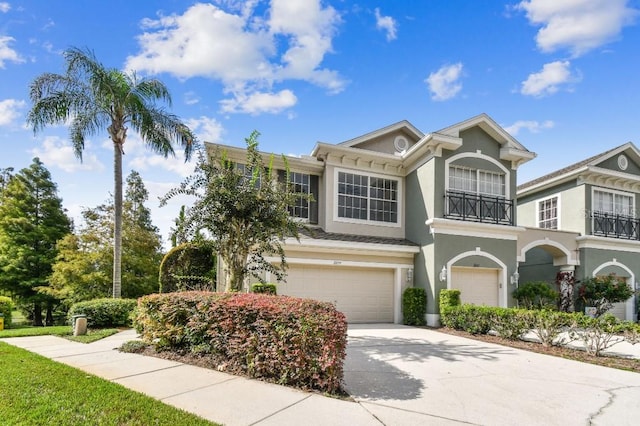 townhome / multi-family property featuring a balcony and a garage