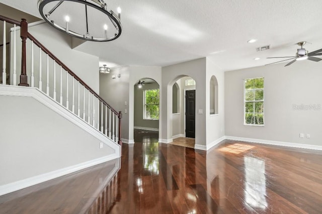 foyer featuring dark hardwood / wood-style floors, ceiling fan, a textured ceiling, and a wealth of natural light