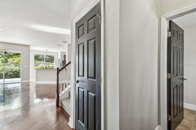 corridor with hardwood / wood-style flooring