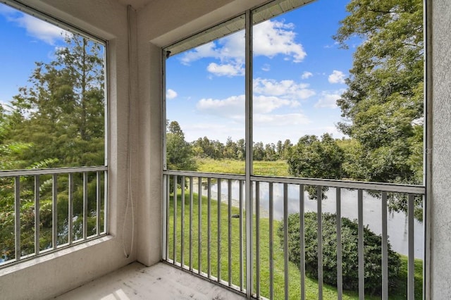 unfurnished sunroom with a water view