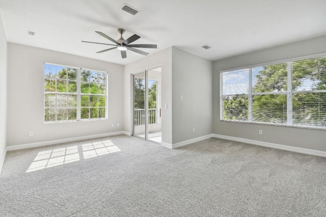 carpeted spare room with ceiling fan