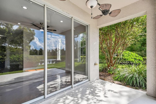 doorway to outside featuring ceiling fan