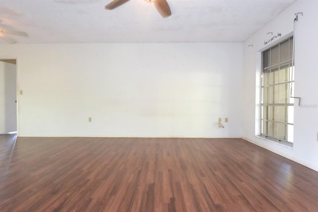 unfurnished room with a textured ceiling, ceiling fan, and dark hardwood / wood-style flooring