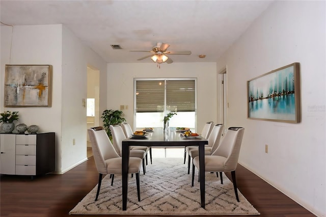 dining space with ceiling fan and dark hardwood / wood-style flooring