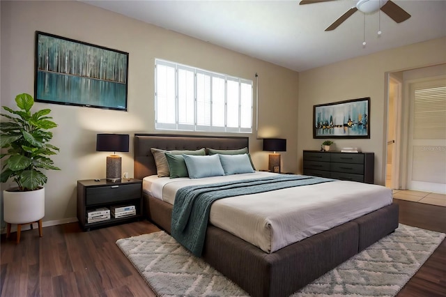 bedroom with dark hardwood / wood-style floors and ceiling fan