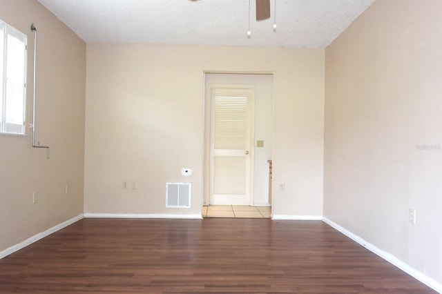 unfurnished room featuring a textured ceiling, wood-type flooring, and ceiling fan