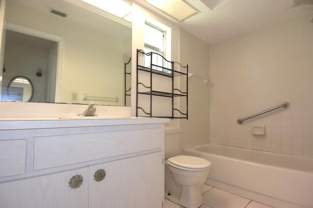 bathroom with vanity, a textured ceiling, toilet, and tile patterned flooring