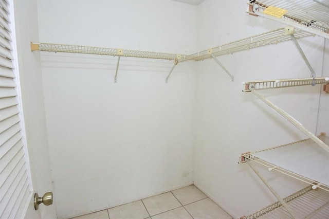 spacious closet featuring light tile patterned floors