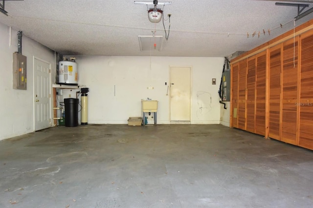 garage featuring a garage door opener, water heater, and electric panel