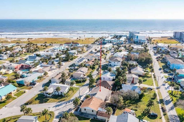 birds eye view of property featuring a water view and a beach view