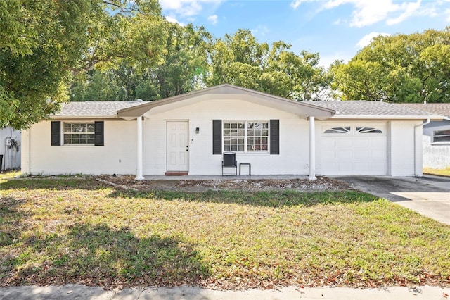 single story home with a garage, a front yard, concrete driveway, and brick siding