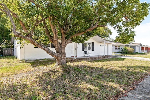 7240 Nova Scotia Dr, Port Richey, FL 34668 - view of front facade with driveway, a garage, fence, and a front yard