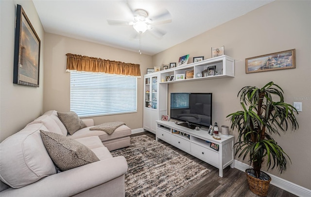 living room with ceiling fan and dark hardwood / wood-style flooring