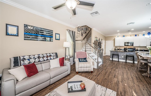 living room featuring ornamental molding, dark wood-type flooring, and ceiling fan