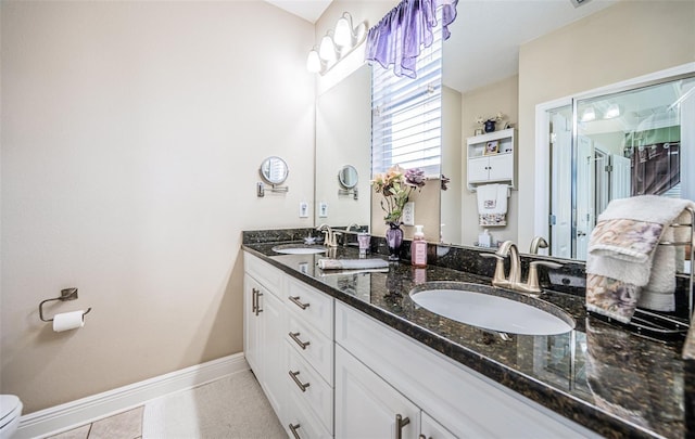 bathroom with vanity, toilet, and tile patterned floors